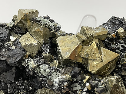 Octahedral Pyrite with Magnetite and Calcite