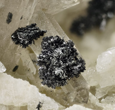 Pyrophanite with Feldspar and Quartz (variety smoky). 