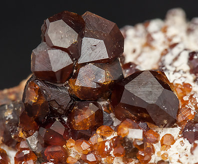 Spessartine with Quartz (variety smoky) and Feldspar. 