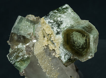 Fluorapatite with Quartz, Siderite and Muscovite. 