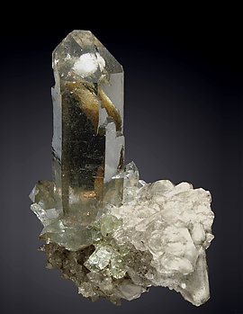 Quartz (variety smoky) with inclusions and Chlorite. 