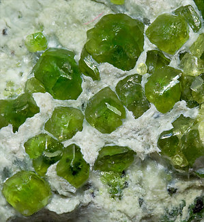 Andradite (variety demantoid) with Amphibole. 