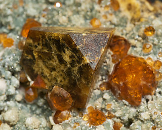 Helvine with Spessartine, smoky Quartz and Chlorite. 