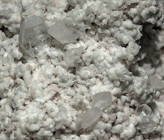 Stokesite with Albite, Microcline, smoky Quartz and Muscovite. 