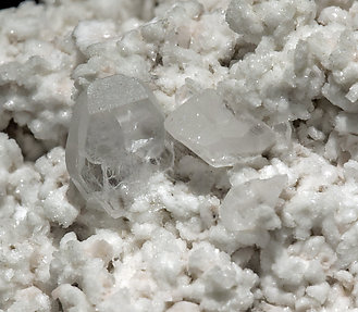 Stokesite with Albite, Microcline, smoky Quartz and Muscovite. 